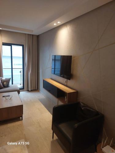 a living room with a couch and a flat screen tv at One Bedroom Luxurious Suites in Casablanca