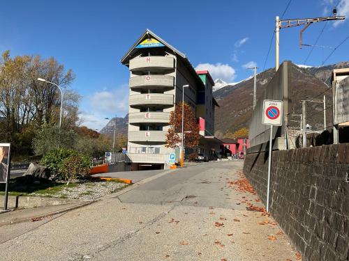 a building on the side of a street next to a road at Hotel Liberty Self Check-In in Bellinzona