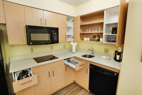 a small kitchen with a sink and a microwave at Staybridge Suites Columbia - Baltimore by IHG in Columbia