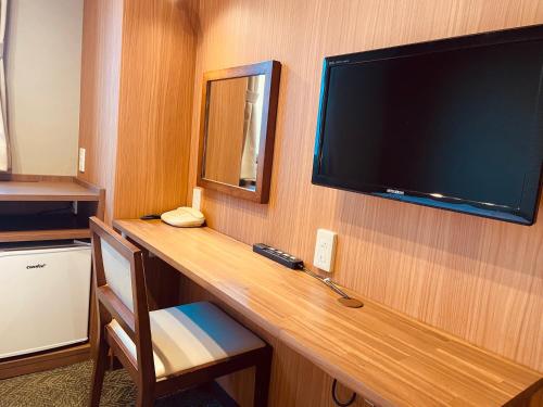 a large flat screen tv on a wall in a hotel room at Shizuoka Town Hotel in Shizuoka