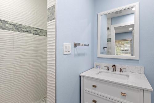 a bathroom with a sink and a mirror at Palm Retreat - 3BR Cottage at the Palmview Inn of Sanibel Island with Bikes in Sanibel