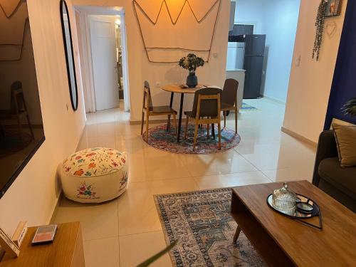 a living room with a table and chairs at Duke of the Dead Sea Crown Group Collection in Neve Zohar