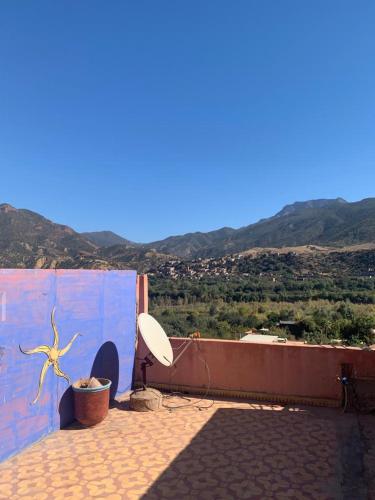 a room with a blue wall with a satellite dish at Grand Atlas Guesthouse à 43 km from Marrakech in Asguine