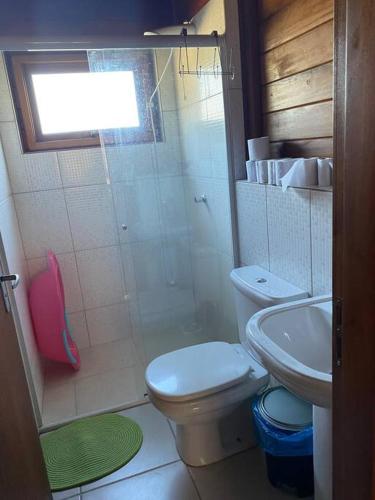 a bathroom with a shower and a toilet and a sink at Sítio da Paz - Pinheira Sc in Palhoça