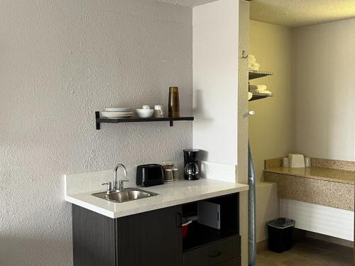 a kitchen with a sink and a counter top at Motel 6 Mesquite, TX Town East in Mesquite