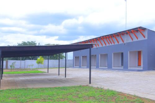 a large blue building with a large roof at Lis ville guest house in Phalaborwa