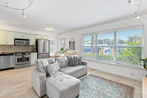 a living room with a couch and a kitchen at Las Olas Blvd Waterfront Apt in Fort Lauderdale