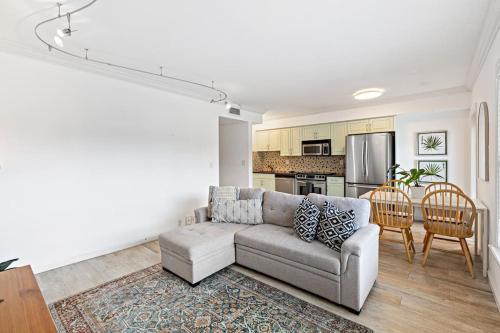 a living room with a couch and a kitchen at Las Olas Blvd Waterfront Apt in Fort Lauderdale