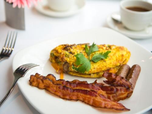 a plate of food with bacon and eggs and a cup of coffee at Grand Traverse Resort and Spa in Traverse City