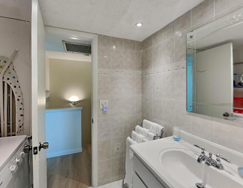 a bathroom with a sink and a mirror at Madeira Beach Yacht Club 247f in St Pete Beach