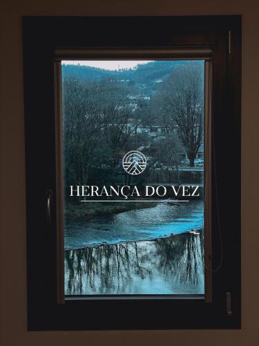 a window with the sign for the herzana do velez at Apartamentos Herança do Vez in Arcos de Valdevez