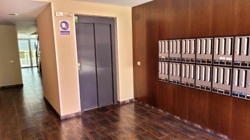 a hallway with a blue door in a building at Entre el mar y PortAventura 2 in Salou