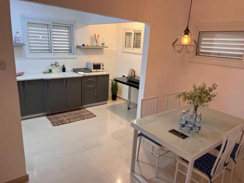 a kitchen with a table and a counter top at Duchess of the Dead Sea Crown Group Collection in Neve Zohar