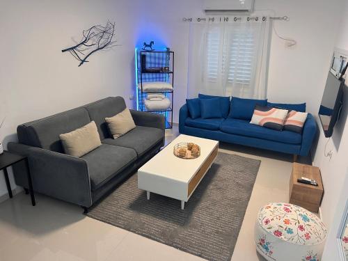 a living room with a couch and a coffee table at Duchess of the Dead Sea Crown Group Collection in Neve Zohar
