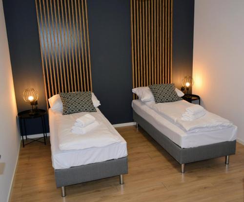 Postel nebo postele na pokoji v ubytování Leśna Muzyka Apartment Limanowa