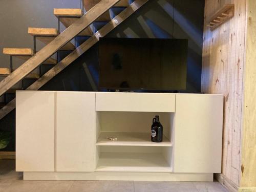 a white cabinet with a bottle inside of it at Galpon de Burgos - SalePatagonia in San Martín de los Andes