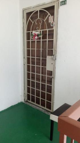 a door with a gate with a green floor in a room at Moona Sweet Home 1 in Batu Caves