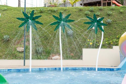 two palm trees in a pool at a resort at Vinhedo Plaza Hotel in Vinhedo