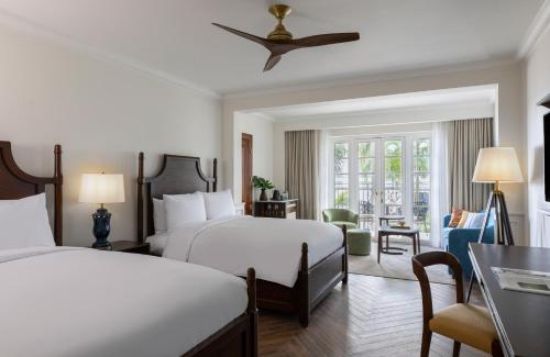 a hotel room with two beds and a table at Sofitel Legend Casco Viejo, Panama City in Panama City