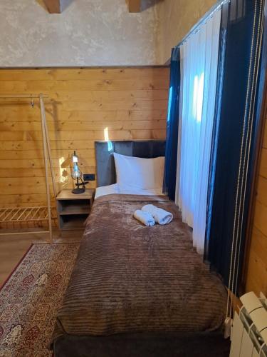 a bedroom with a large bed with blue curtains at Rooms and apartmants Mirovic in Kolašin