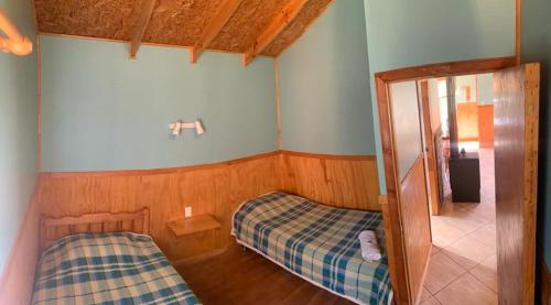 Una cama o camas en una habitación de Cabañas Don Lino