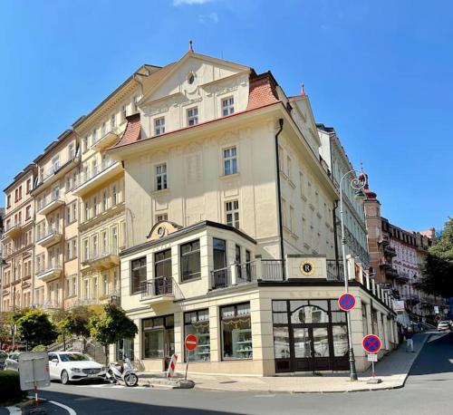 a large building on the corner of a street at Huge two floor apartment on the Park Colonnade with free parking for one car, 160 sqm in Karlovy Vary