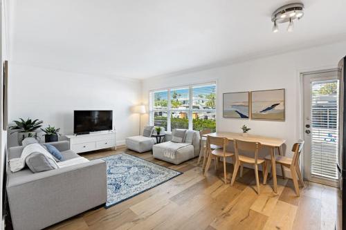 a white living room with a table and a couch at Beach Apt with Waterview in Las Olas Blvd in Fort Lauderdale