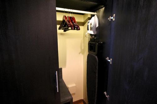 a bathroom with a door open with a baseball glove at Hilton Garden Inn Lima Surco in Lima