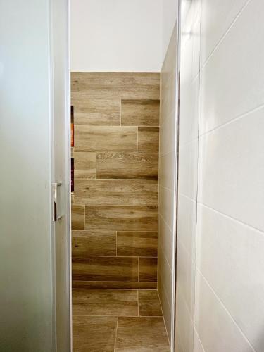 a bathroom with a wooden wall at Sorokos House in Dhragoulás