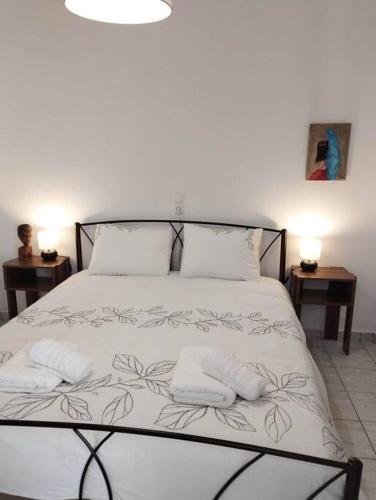 a bedroom with a bed with two towels on it at Arta House in Arta