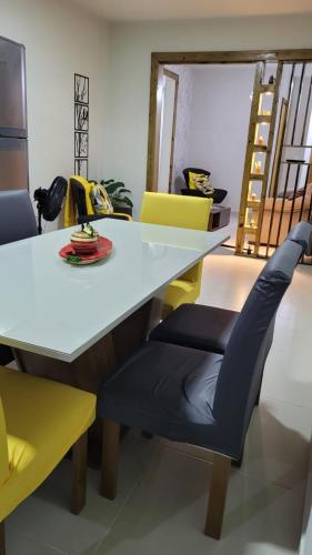 a dining room with a white table and chairs at Marques Home in Porto Belo
