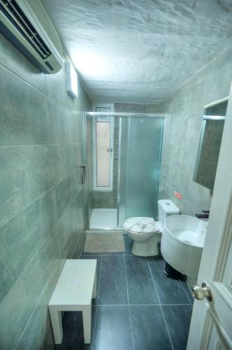 a bathroom with a shower and a toilet and a sink at Charming 3 storey apartment in Valletta centre, NGRI1-1 in Valletta