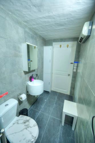 a bathroom with a white toilet and a sink at Charming 3 storey apartment in Valletta centre, NGRI1-1 in Valletta