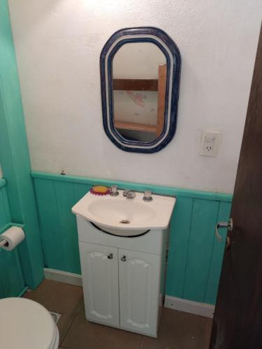 a bathroom with a sink and a mirror on the wall at Hermoso Duplex familiar en Zona Norte in Mar del Plata
