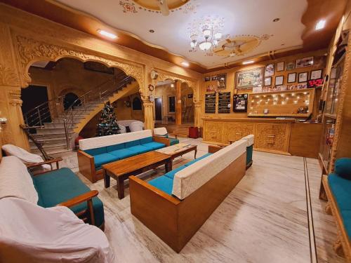 a room with couches and chairs and a staircase at Hotel Tokyo Palace in Jaisalmer