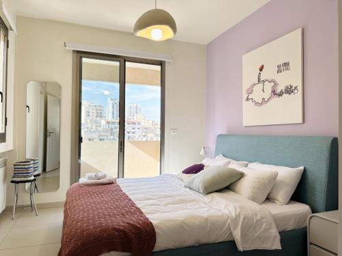 um quarto com uma cama e uma grande janela em Cloud Number 10 em Beirute