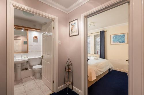 a bathroom with a bed and a toilet and a sink at Pretty Apartment in the Cathedral City of Ripon in Ripon