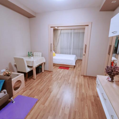 a living room with a bed and a dining room at CBP treasure swimming condo in Chiang Mai