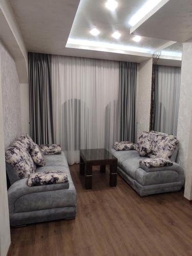 a living room with two couches and a table at Hotel Roma & Tours in Yerevan