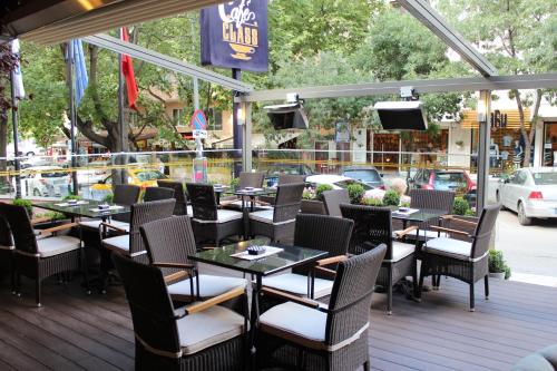 a restaurant with tables and chairs on a deck at Class Hotel in Ankara