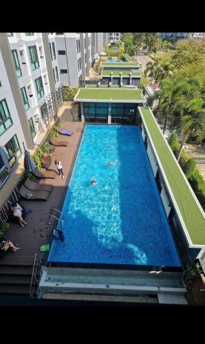 an overhead view of a swimming pool in a building at treasure swimming condo in Chiang Mai