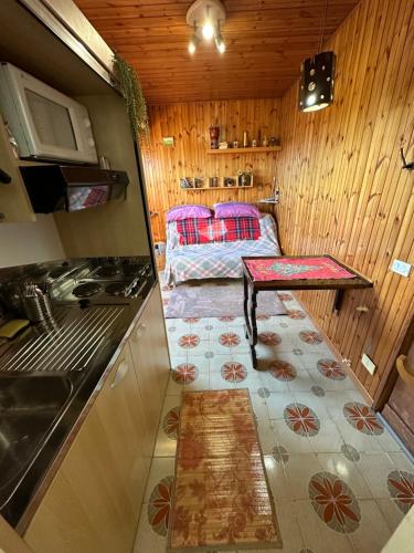 a small kitchen with a table in the middle of a room at Appartamento monolocale Fiuggi 14 MQ piscina dal 20 giugno al 15 settembre in Fiuggi