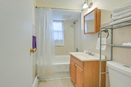 a bathroom with a sink and a tub and a shower at Cozy Bay Shore Condo Near Museums and Outdoor Rec! in Bay Shore