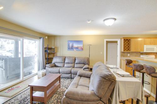 a living room with a couch and a table at First-Floor Big Sky Condo with Hot Tub! in Big Sky