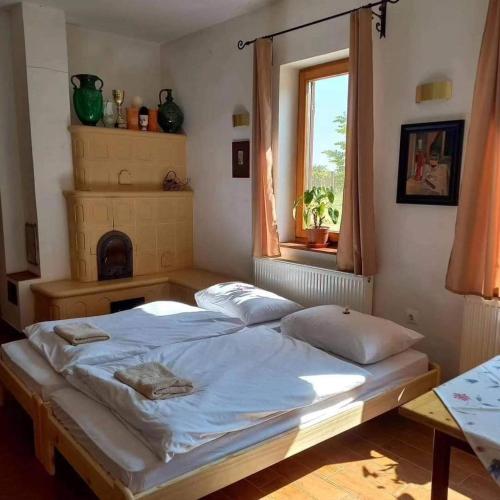 a large bed in a bedroom with a window at Beck Pince in Hajós