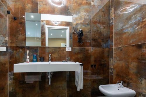 a bathroom with a sink and a mirror at Luxury 144 B&B in Crotone