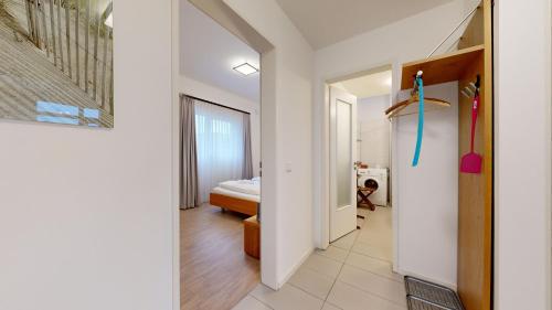 a hallway leading to a bedroom with a bed at DünenResort in Binz, strandnahe und moderne FeWos mit Balkon, teilweise mit Meerblick, in Binz