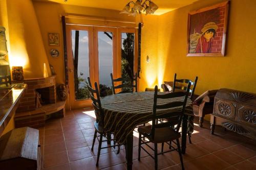 a dining room with a table and chairs in a room at Casa Maria Vista, Espectacular View in Santa Cruz La Laguna