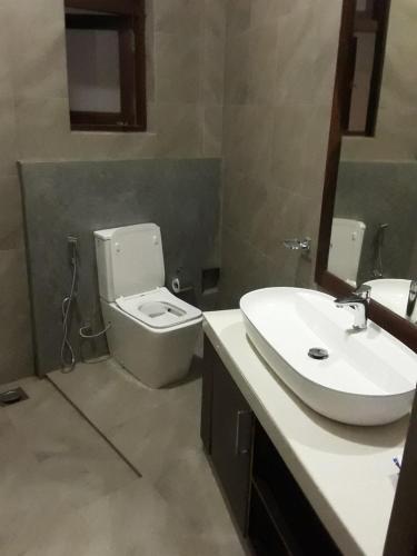 a bathroom with a toilet and a sink at Thalangama Lakeview Lodge in Battaramulla