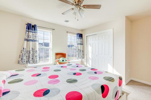 a bedroom with a large bed with a polka dot bedspread at Spacious Ewing Township Home Home Gym and Deck! 
